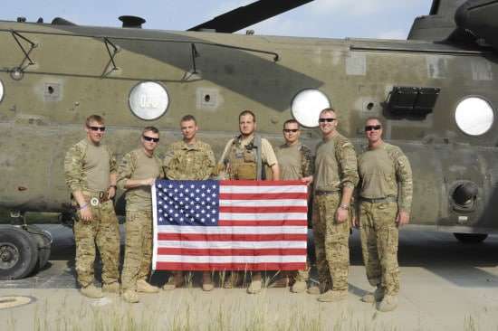 Embed war photographer, Robert L. Cunningham, center, with soldiers from CH-47 crew attached to Task Force Tigershark. The photo was taken at Forward Operating Base (FOB) Salerno in Eastern Afghanistan. 