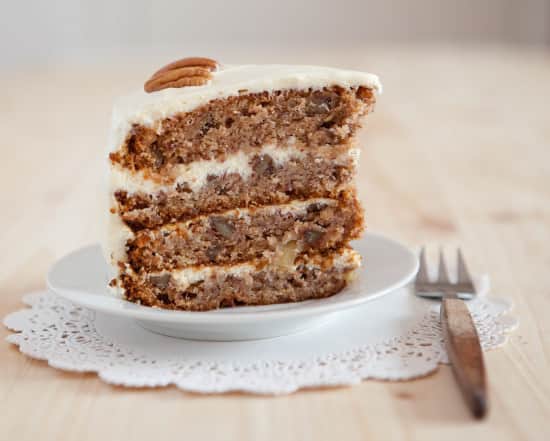A Single Piece Of Hummingbird Cake With Pecans And Cream Cheese Frosting
